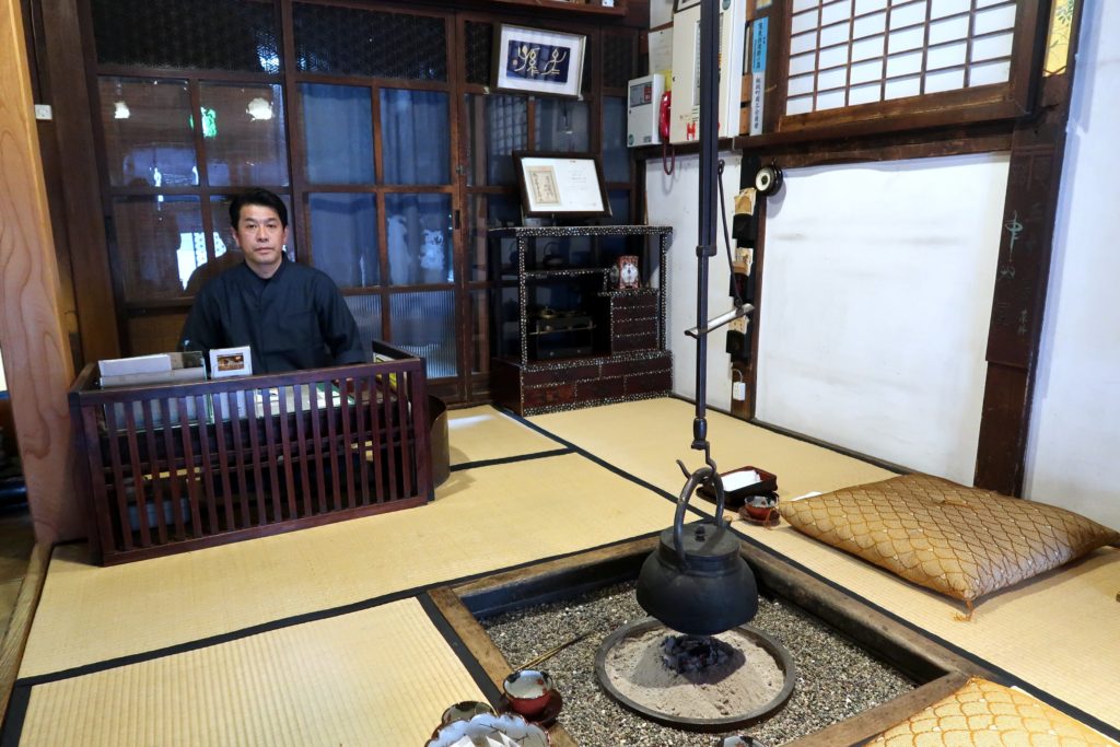 Hiroshi Abe sits at a low desk in the tatami-floor lobby of his 200-year-old Nakamuraya Japanese inn in Iizaka Onsen, Fukushima Prefecture