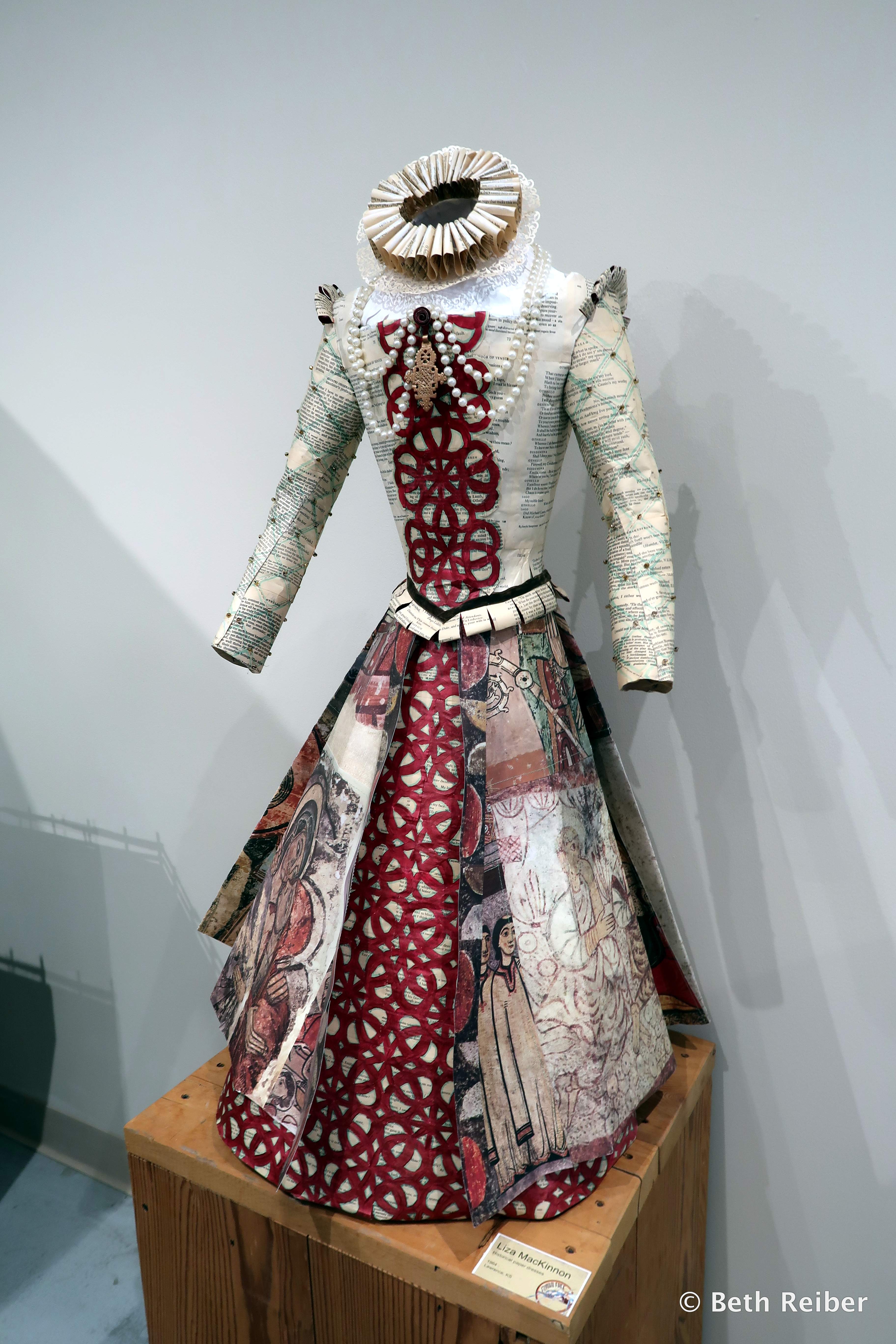 Artist Liza MacKinnon uses pages of books, maps, photographs, currency and other forms of paper to produce historically correct dresses like this one, on display at the Grassroots Art Center in Lucas